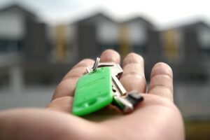 Picture of a person with keys to a home in their hands