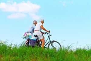 Image of an elderly couple riding bikes